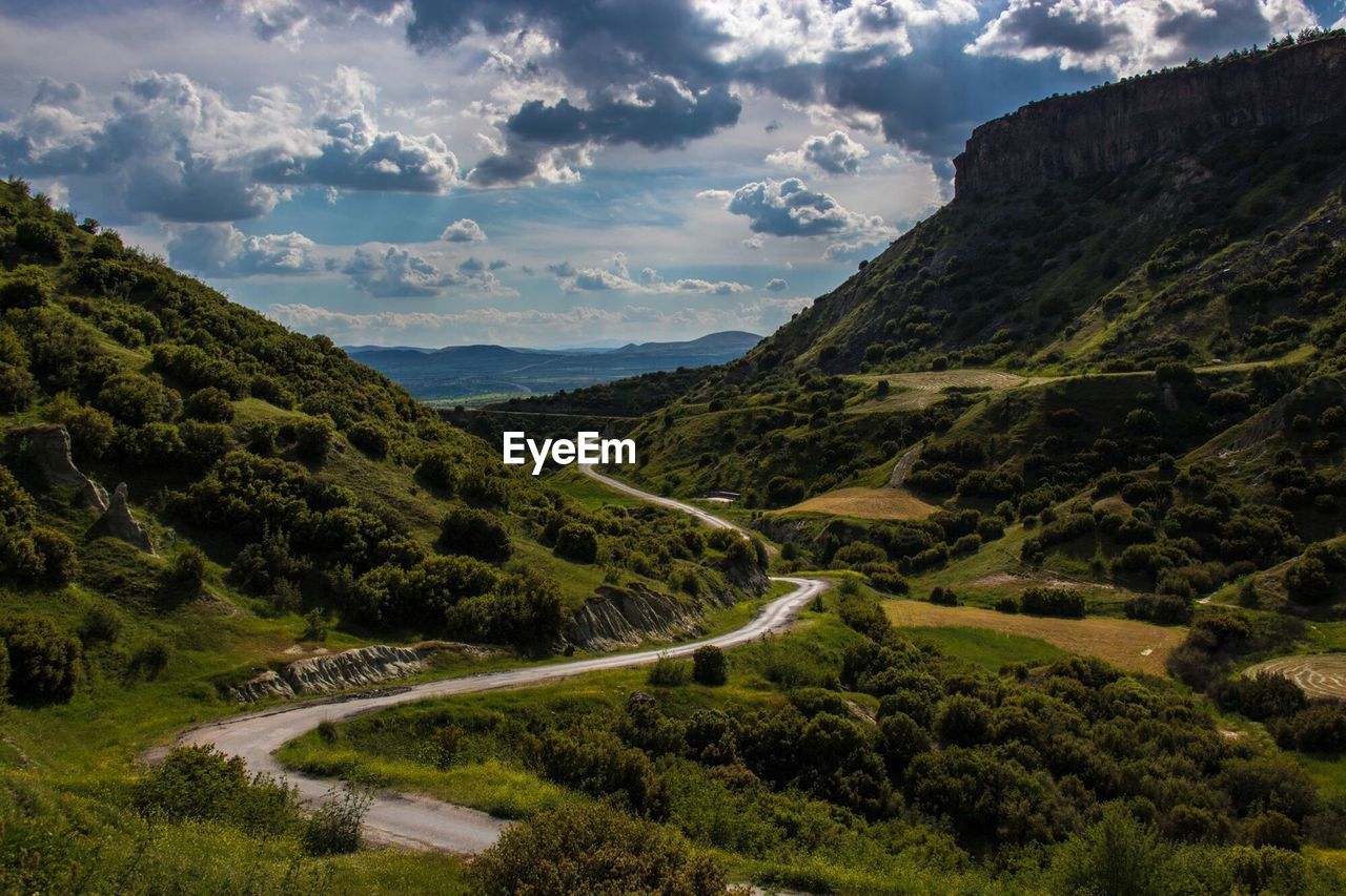 High angle view of curved road along countryside landscape