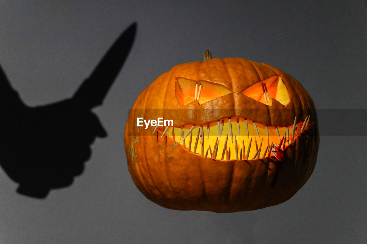 Close-up of illuminated pumpkin against a wall