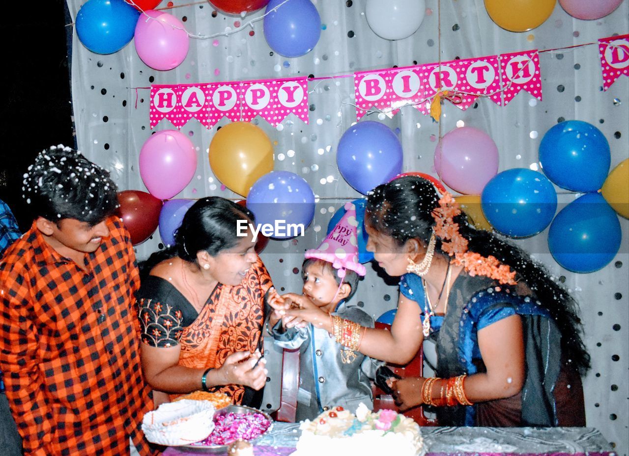 GROUP OF PEOPLE WITH BALLOONS AT NIGHTCLUB