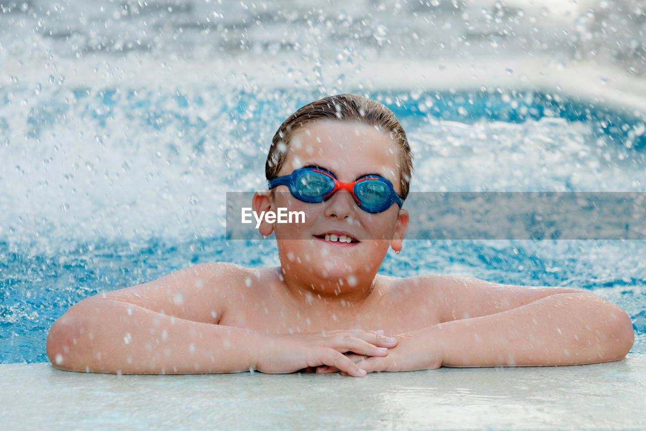 Portrait of happy girl swimming in pool