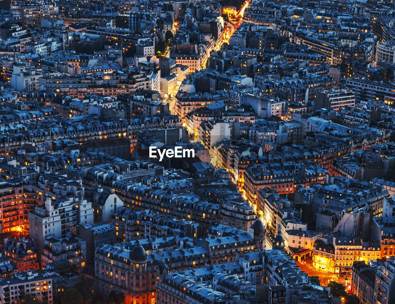 Aerial view of illuminated cityscape at dusk