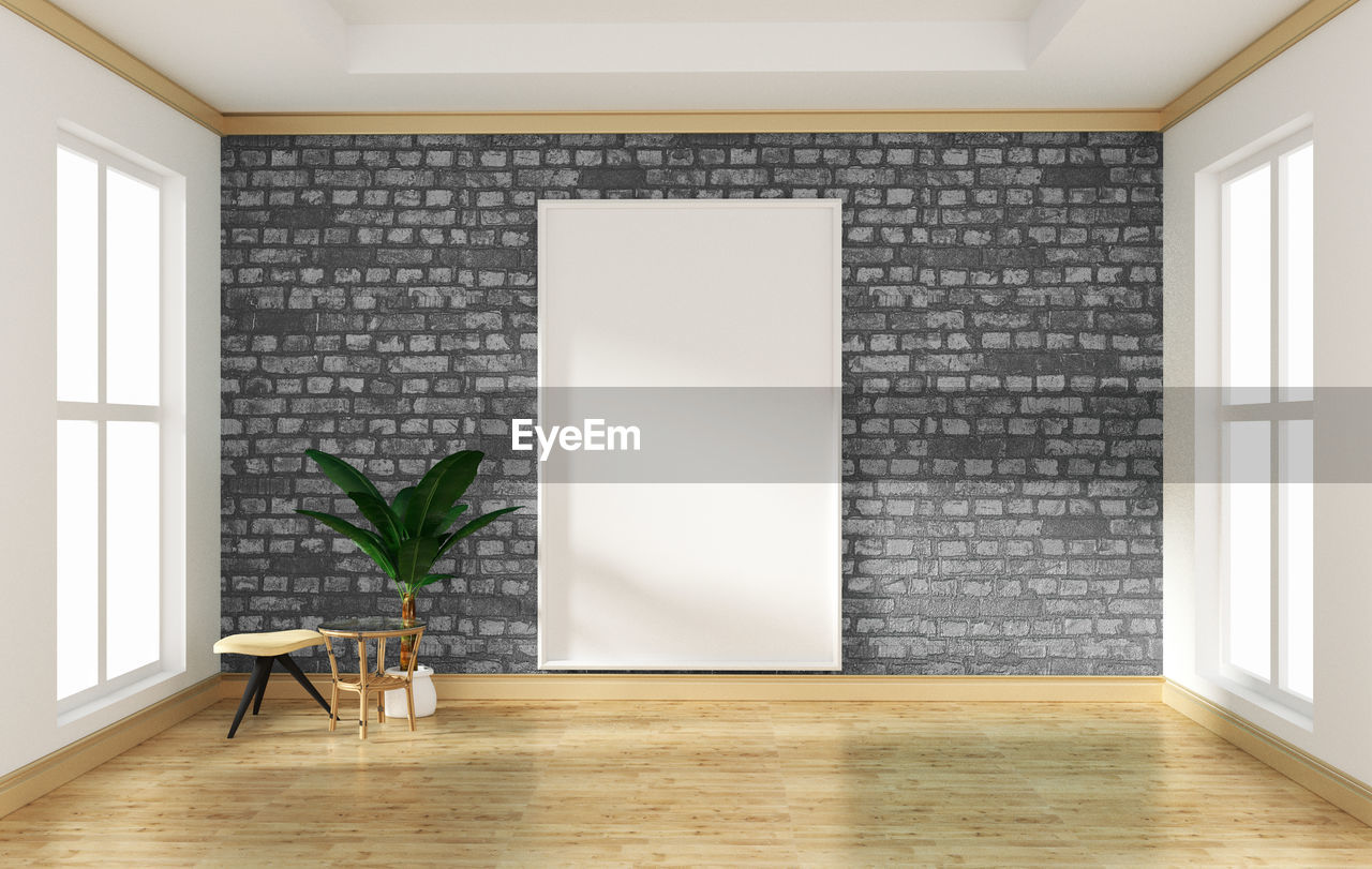 Potted plant on tiled floor against wall