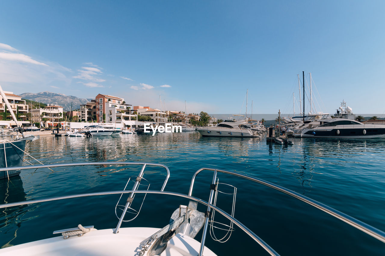 boats in sea against clear blue sky