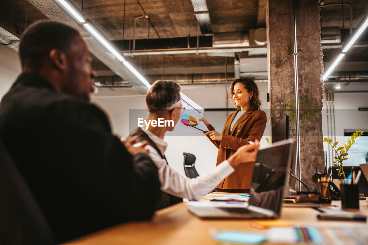 Businesswoman talking with colleagues in office