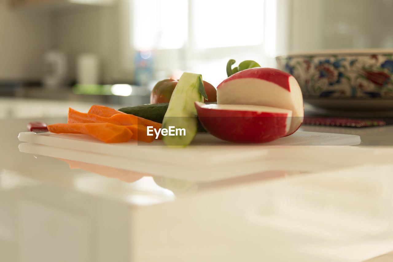 Various vegetables on cutting board in kitchen