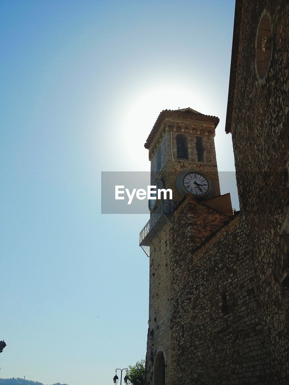 Low angle view of clock tower against clear sky