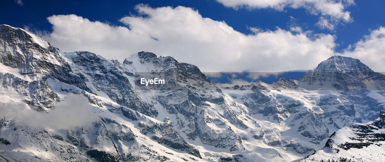 Panoramic view of snowcapped mountains against sky