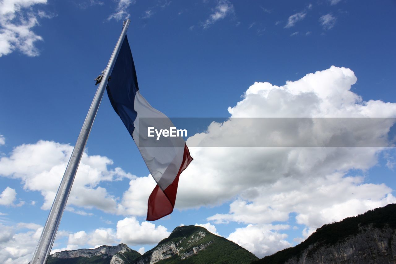 LOW ANGLE VIEW OF FLAGS AGAINST SKY