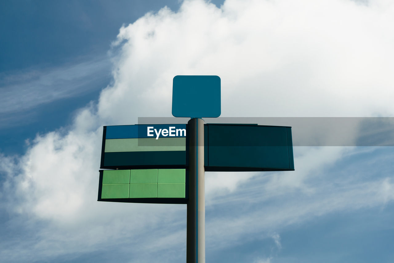 Low angle view of road sign against sky