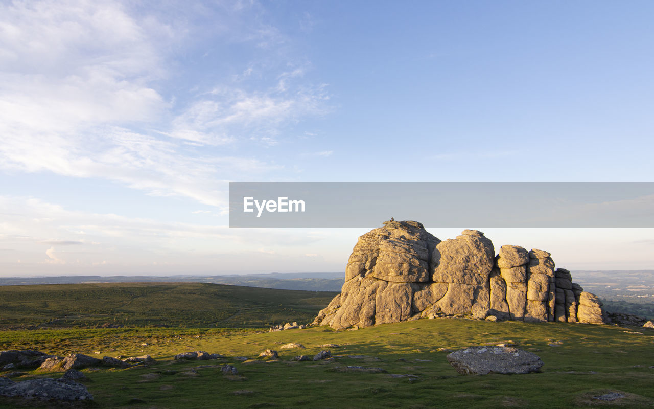 Rock formations on landscape against sky