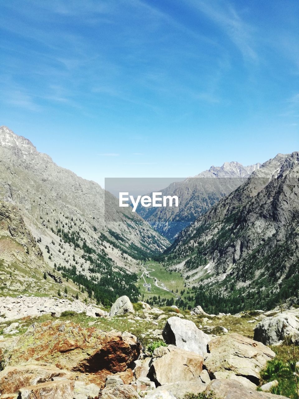 Scenic view of mountains against blue sky