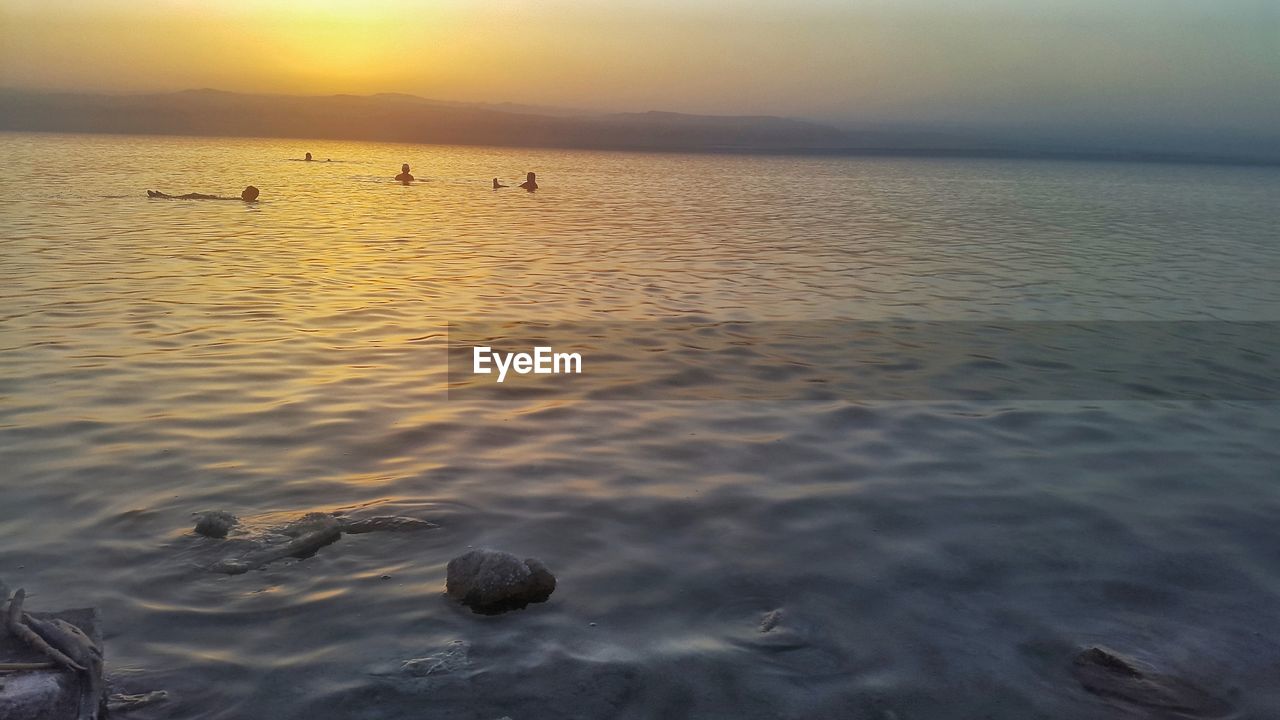 SCENIC VIEW OF SEA AT SUNSET