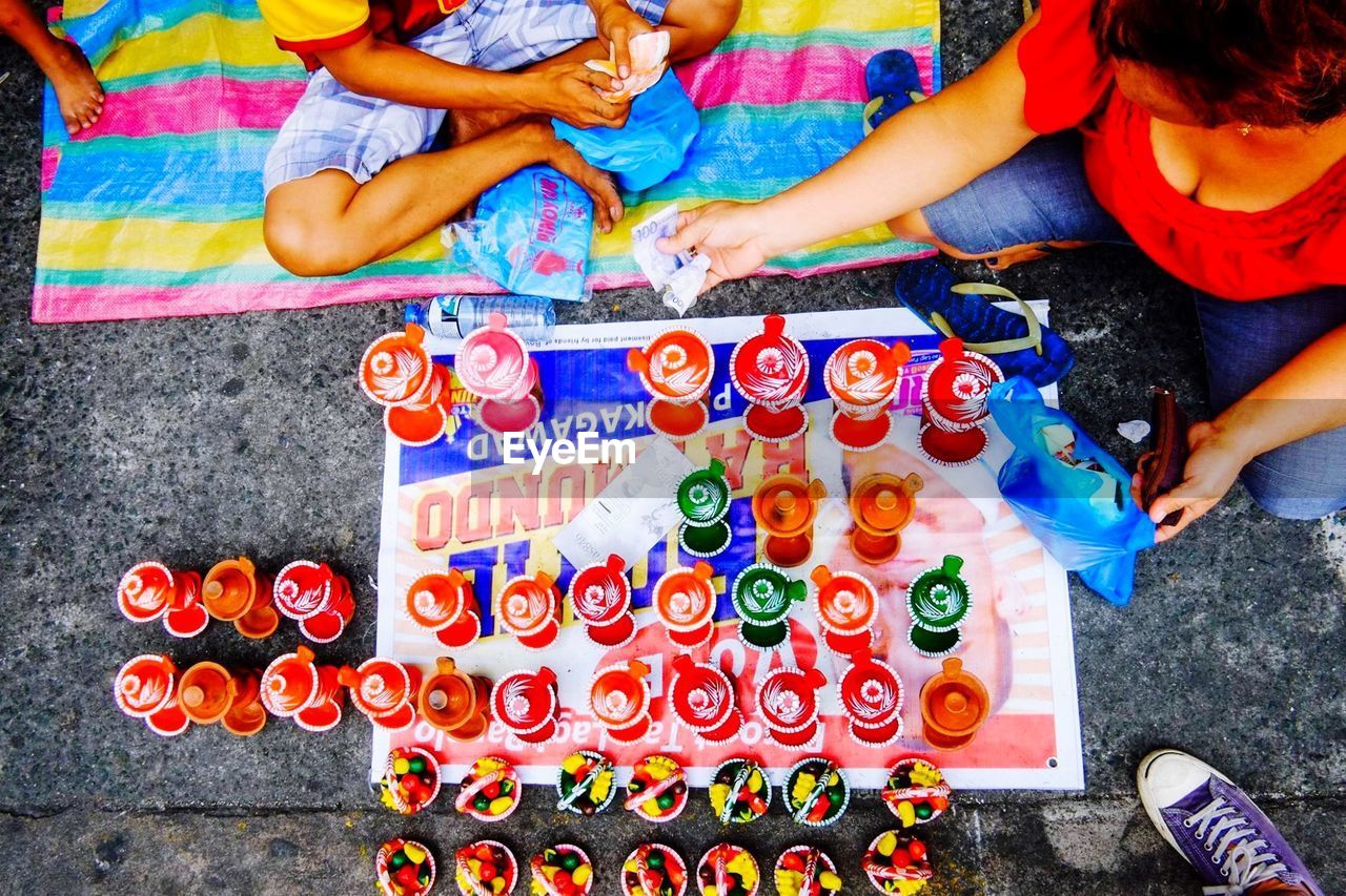 High angle view of woman purchasing crockery from vendor