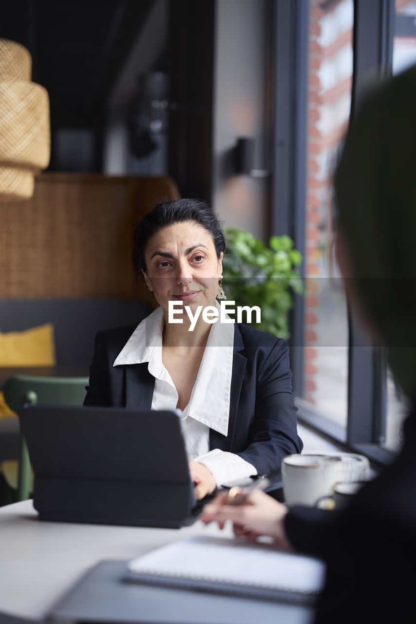 Businesswoman in cafe looking away