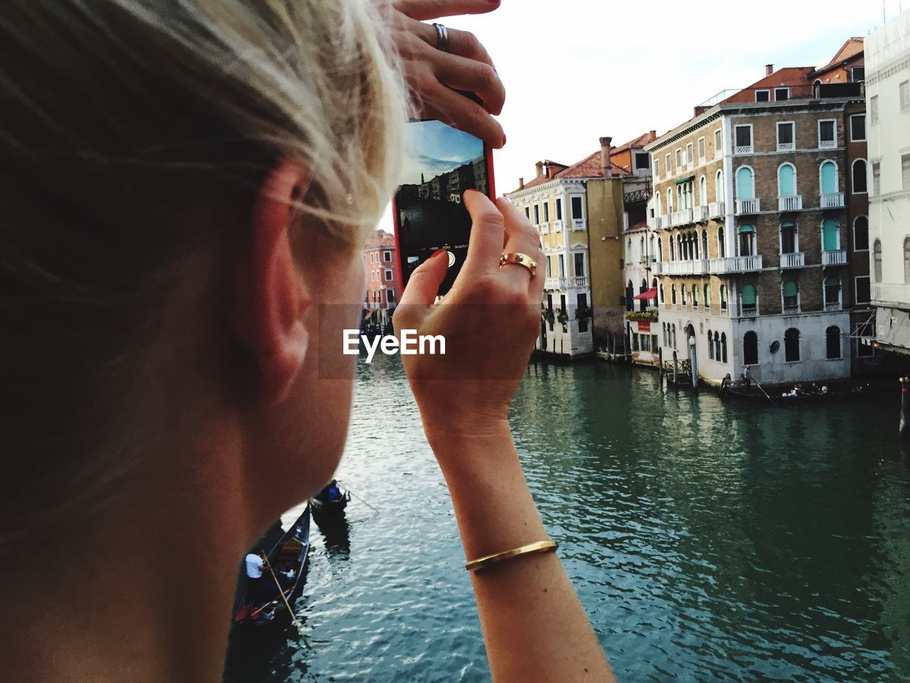 Woman photographing buildings