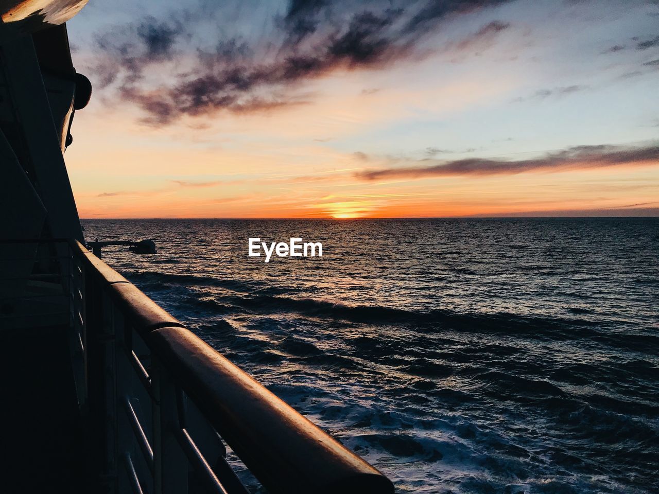 SCENIC VIEW OF SEA AGAINST ORANGE SKY