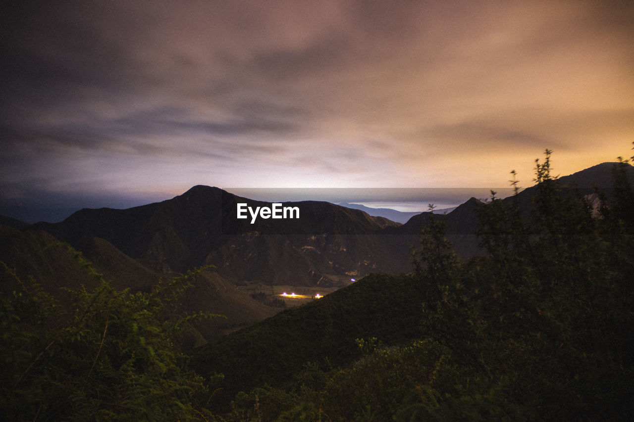 Scenic view of mountains against sky at sunset