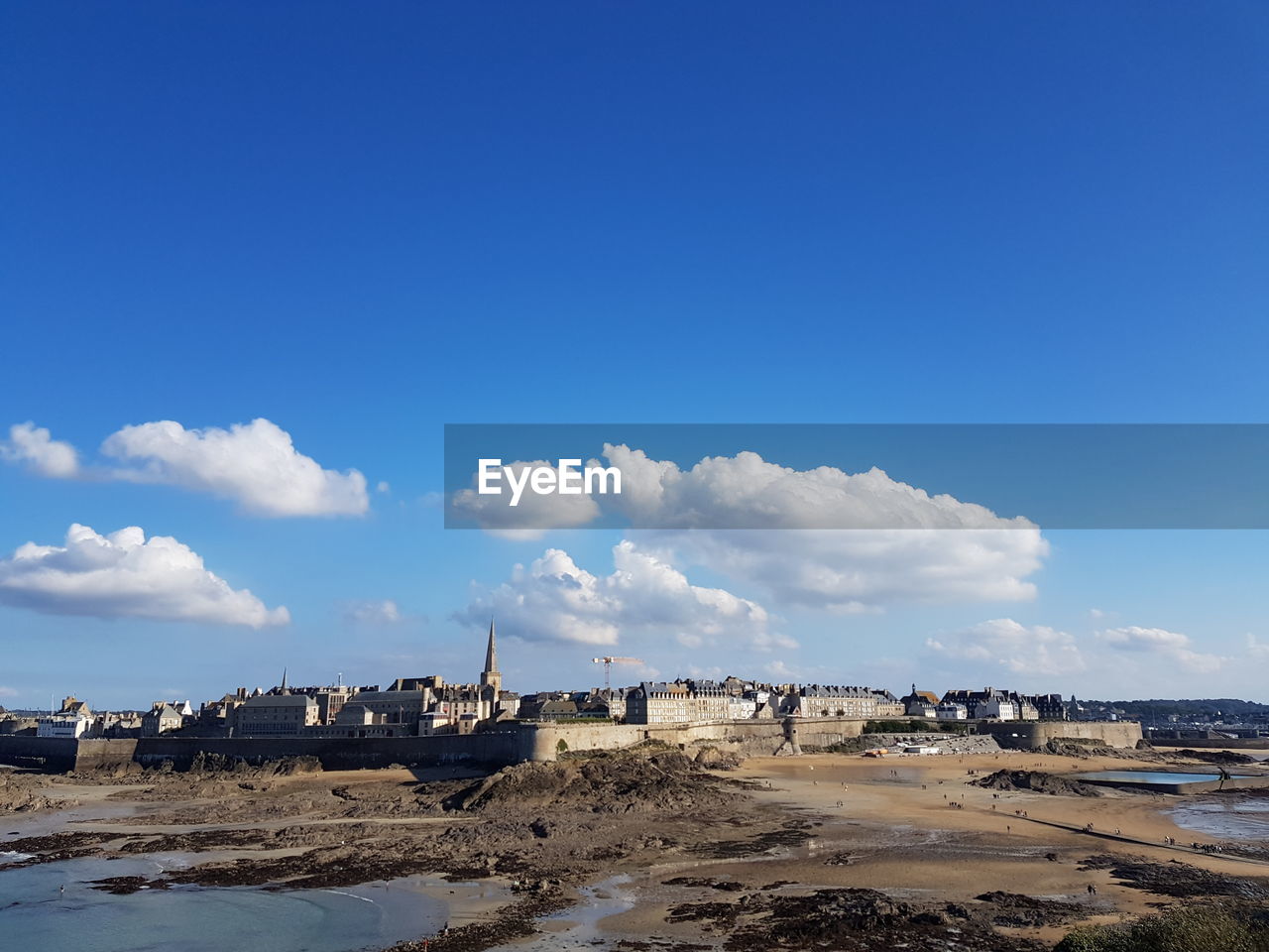 Panoramic view of beach against blue sky