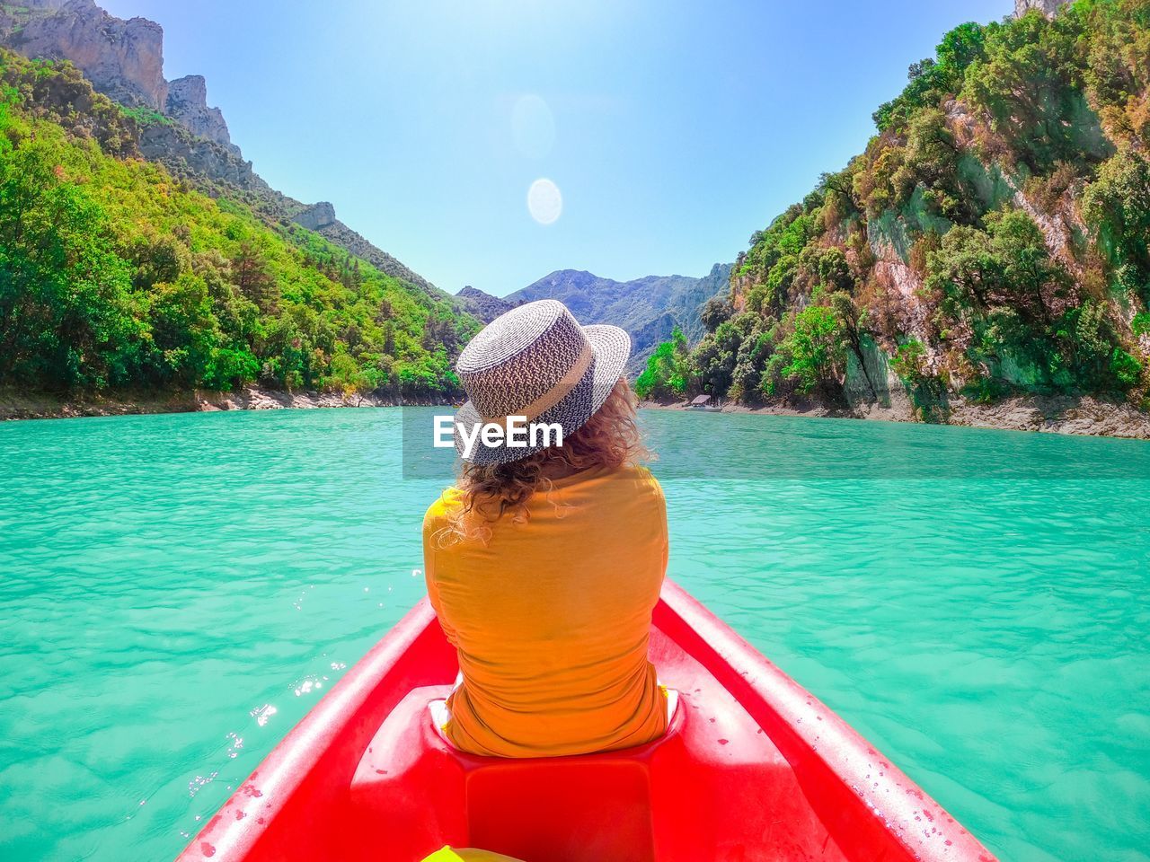 rear view of woman in boat on lake