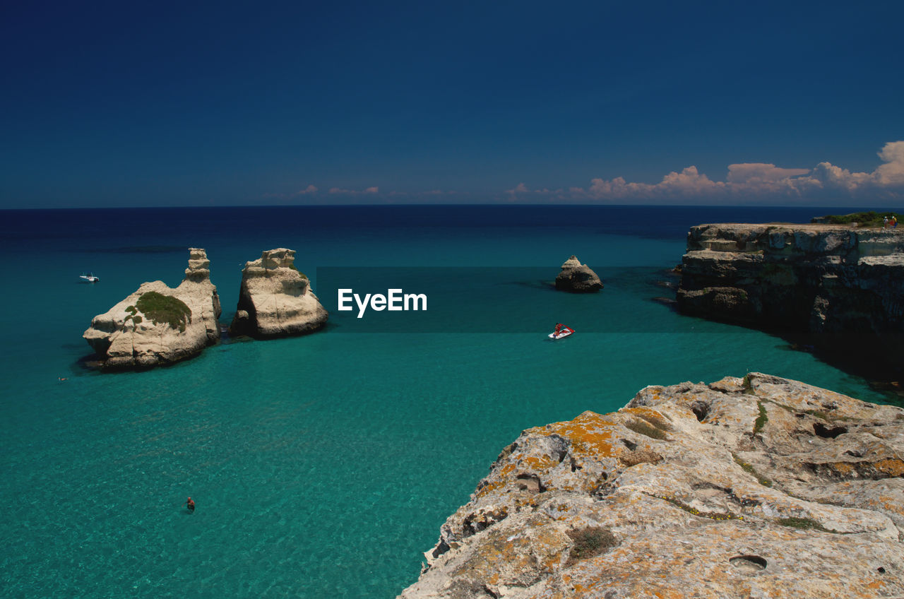 High angle view of rock in sea against sky