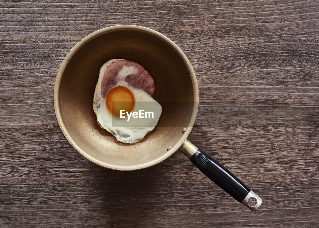 High angle view of fried egg in frying pan on table