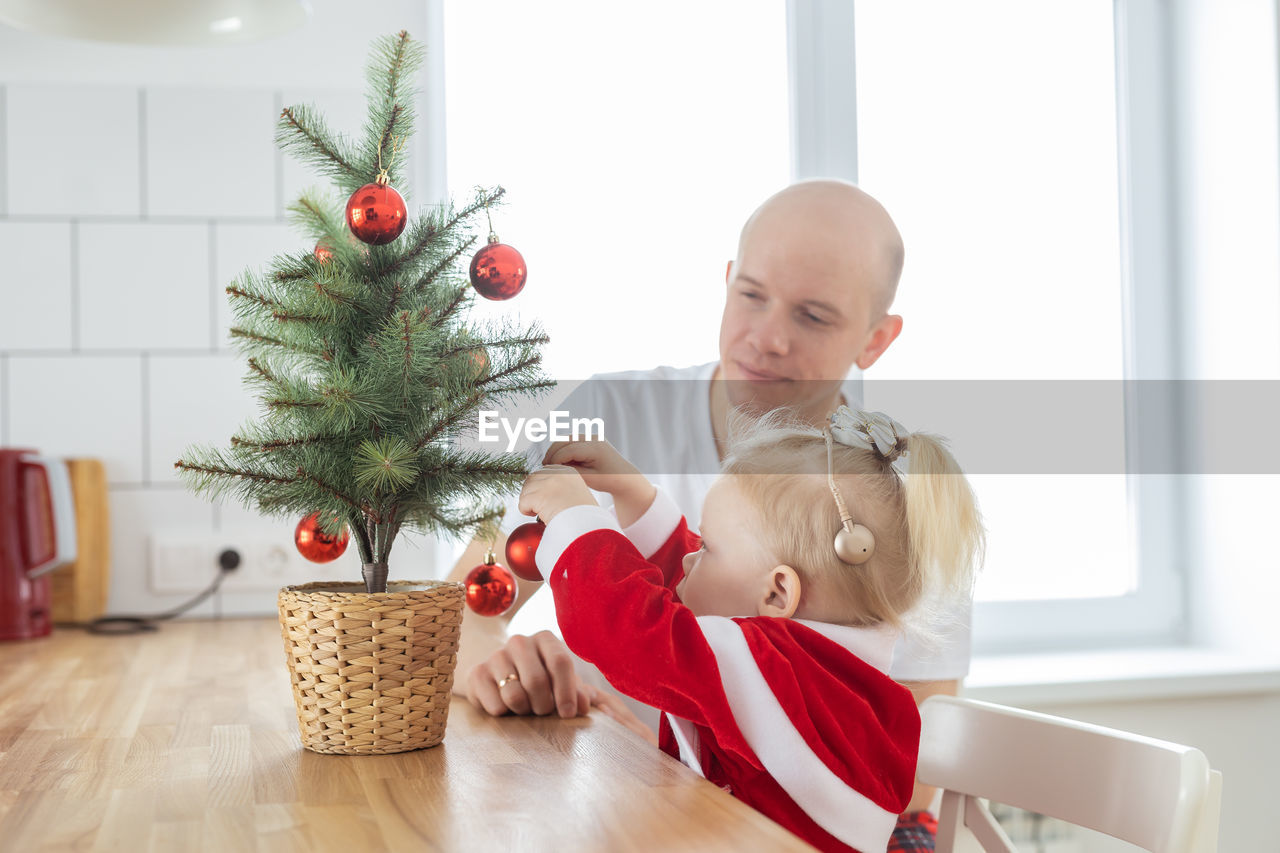 portrait of cute girl playing with christmas tree