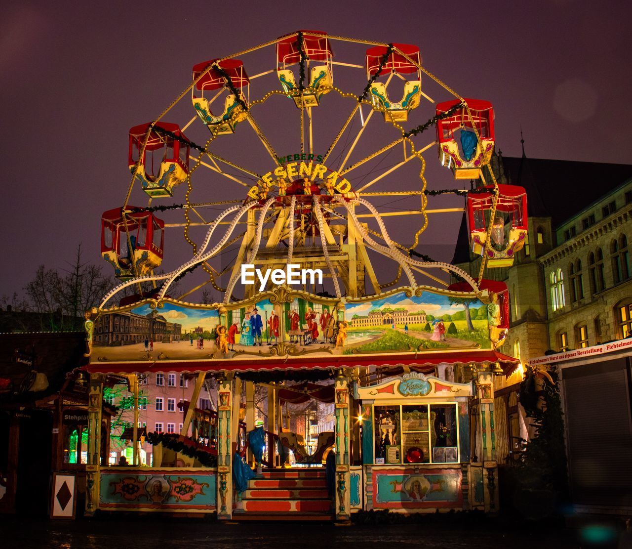 LOW ANGLE VIEW OF FERRIS WHEEL AT NIGHT