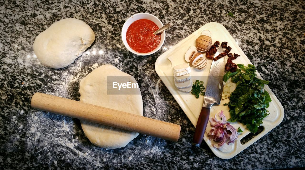 High angle view of pizza ingredients on table