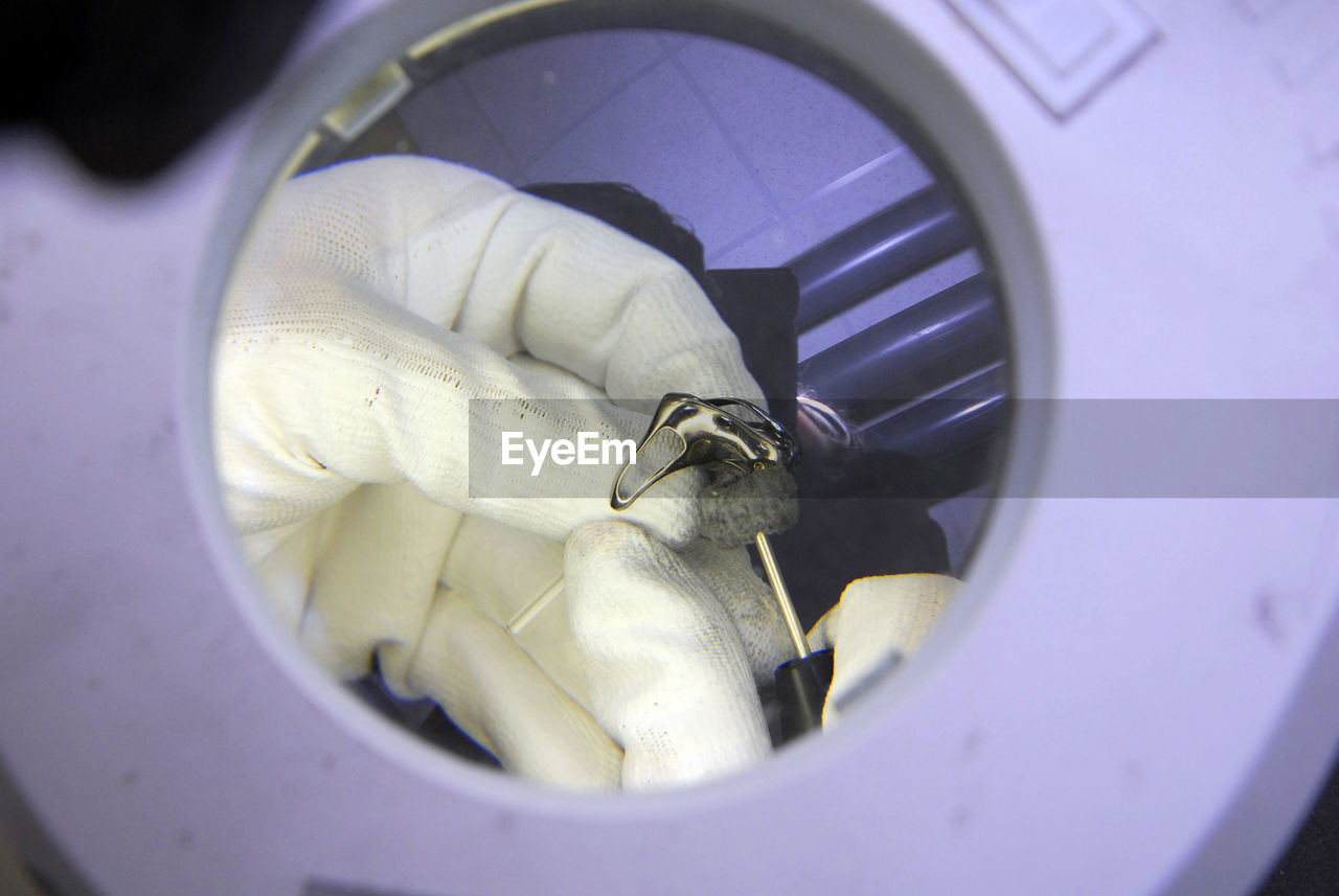 HIGH ANGLE VIEW OF PERSON WORKING IN PURPLE