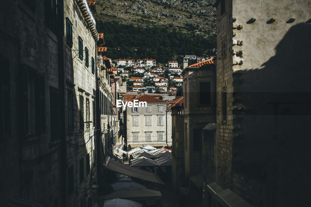 View looking down the center of busy old town dubrovnik buildings