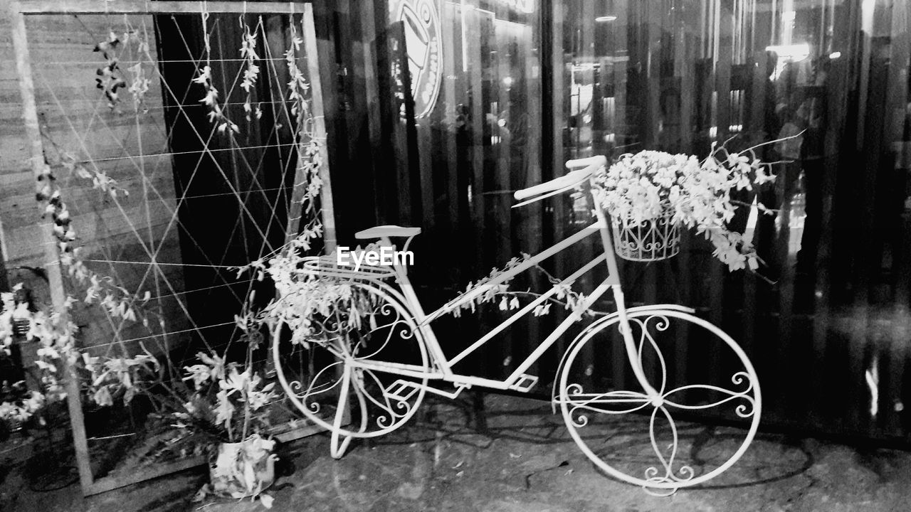Decorated bicycle on footpath at night