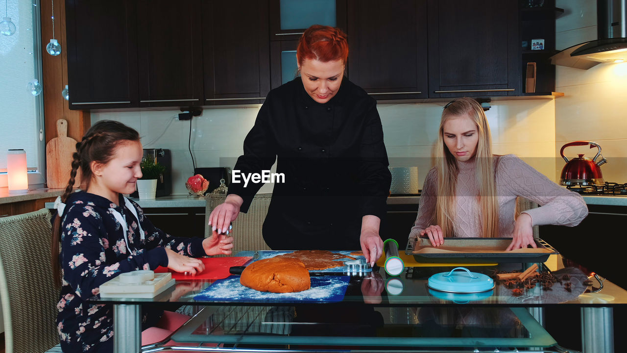 portrait of young woman preparing food at table