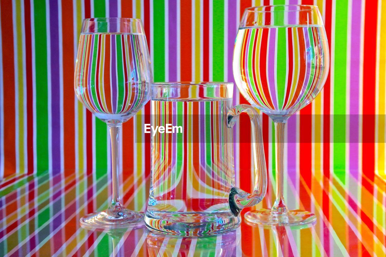 Close-up of glasses against striped background