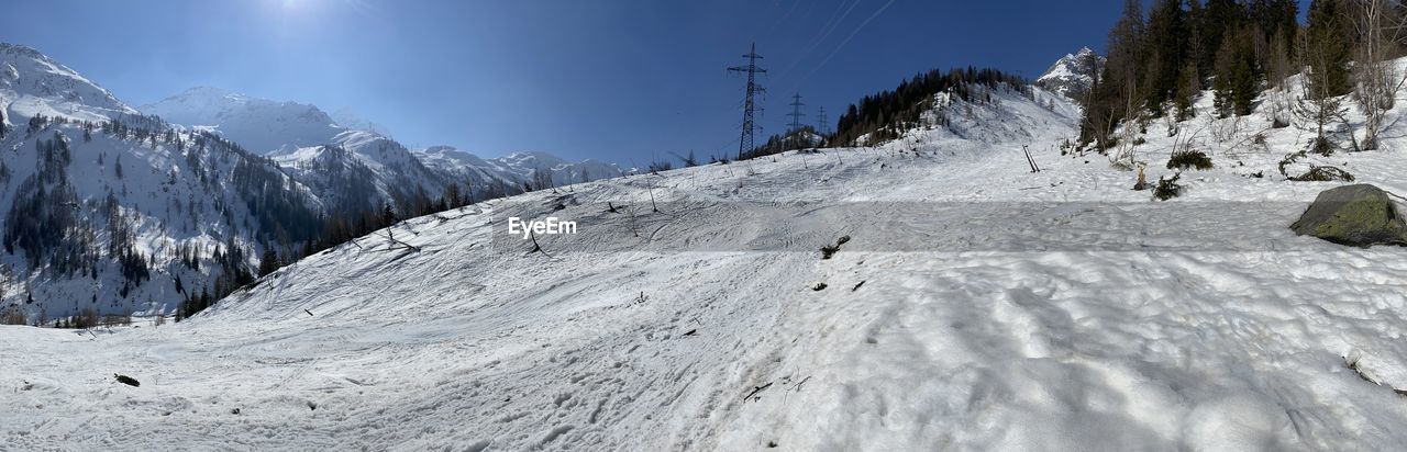 SNOW COVERED MOUNTAINS AGAINST SKY