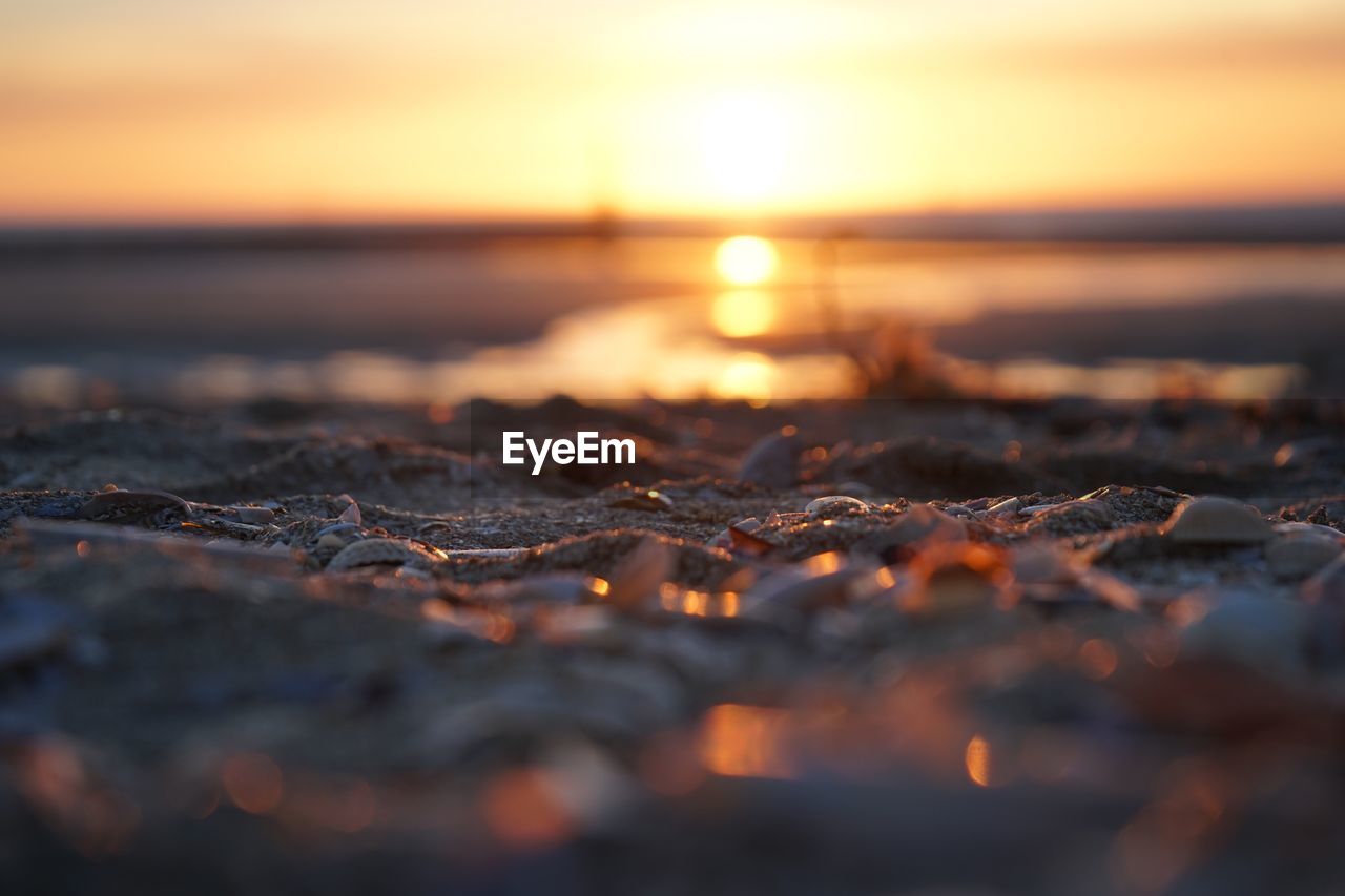 Surface level of pebble beach during sunset 