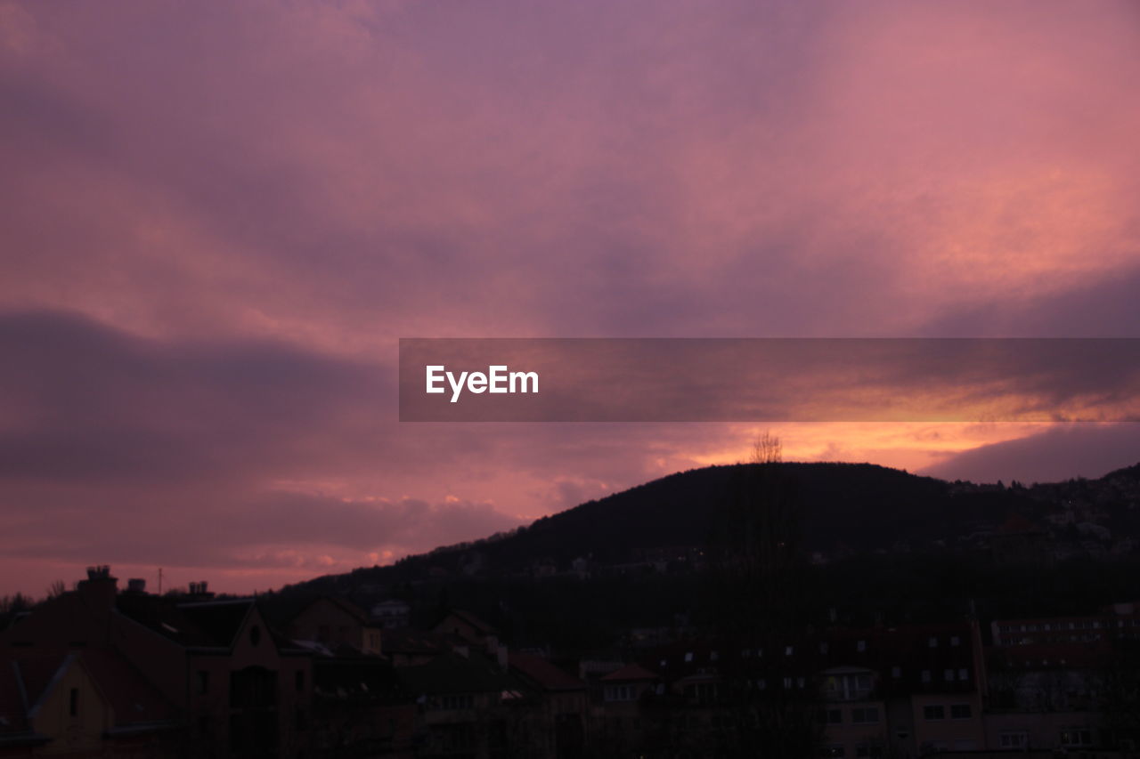 Scenic view of mountains against cloudy sky