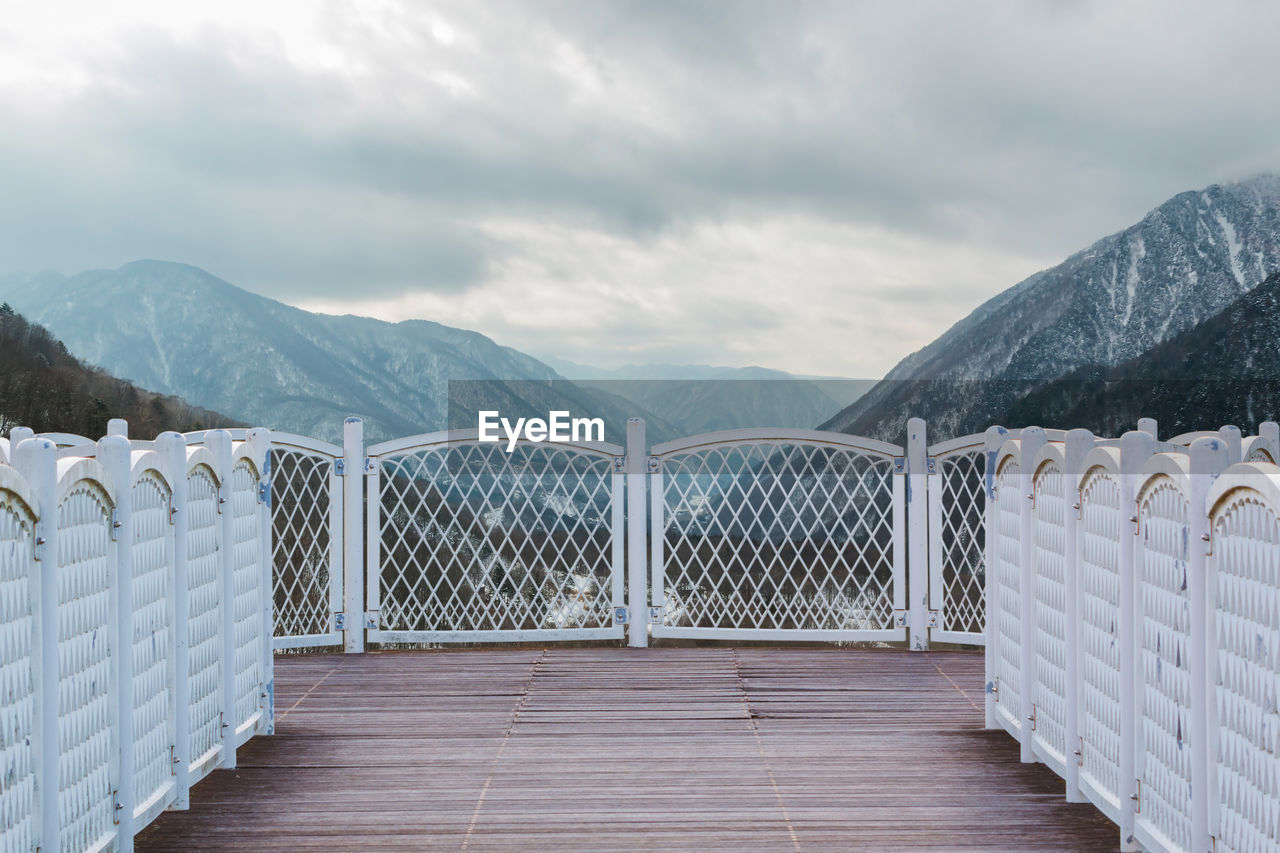 Scenic view of mountains against cloudy sky