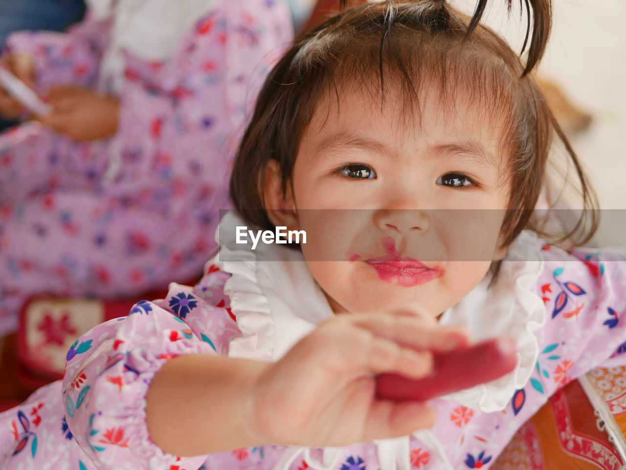 Close-up portrait of cute girl with pink lipstick