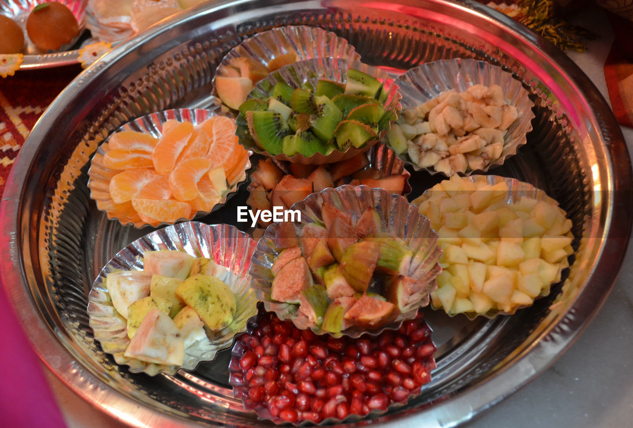 High angle view of various fruits in plates