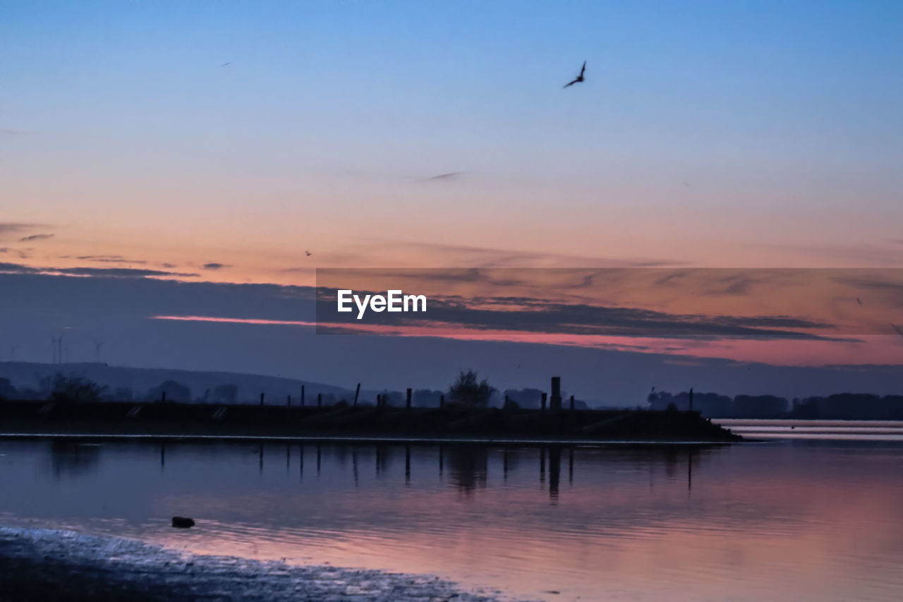 SCENIC VIEW OF LAKE AGAINST ROMANTIC SKY