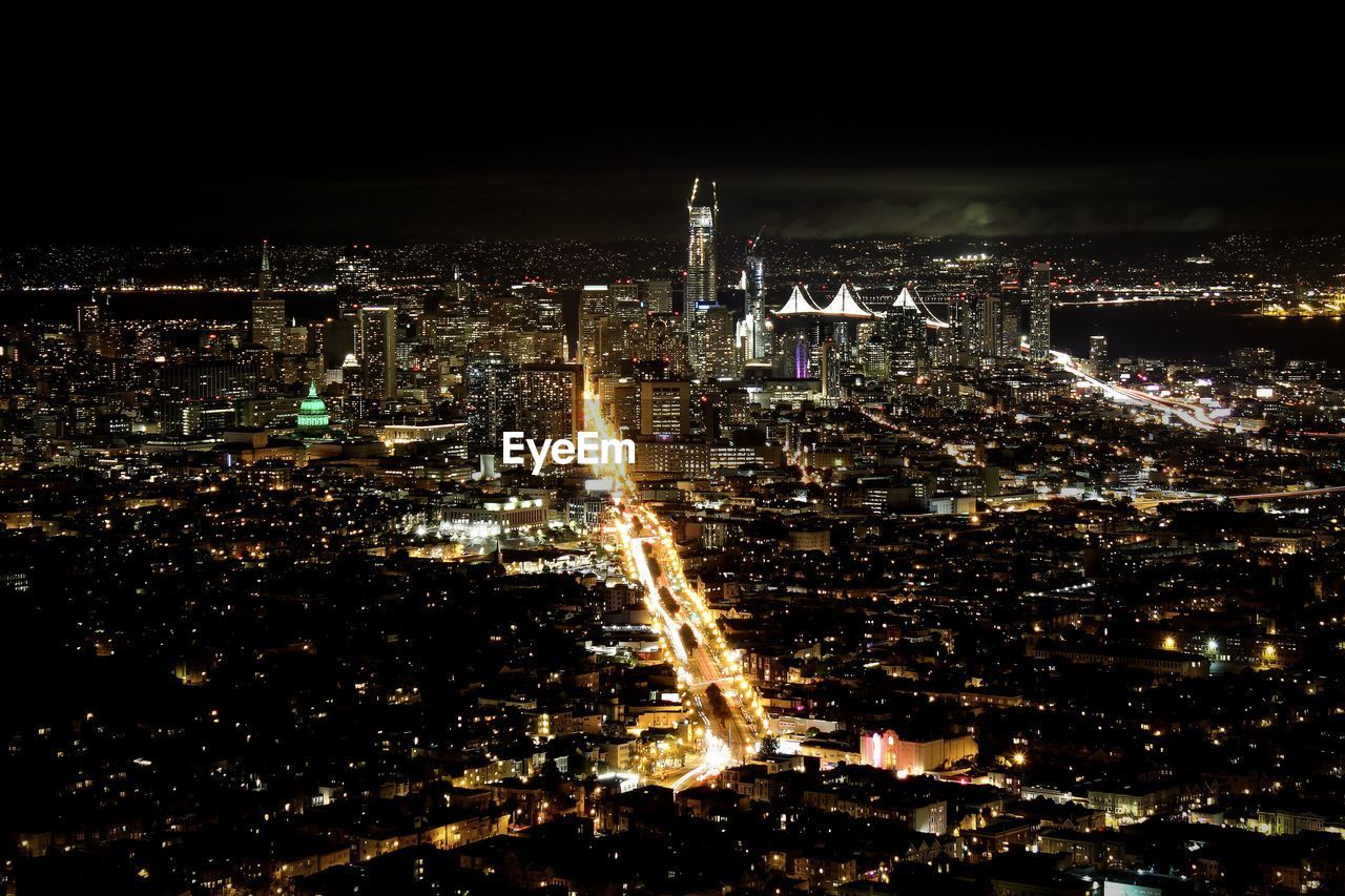 Aerial view of city lit up at night