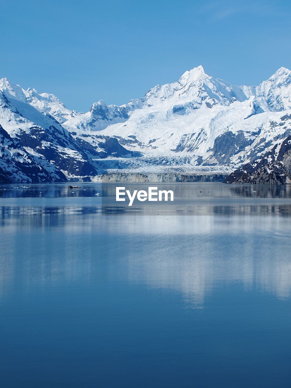 Scenic view of bay and snow covered mountains at glacier bay national park