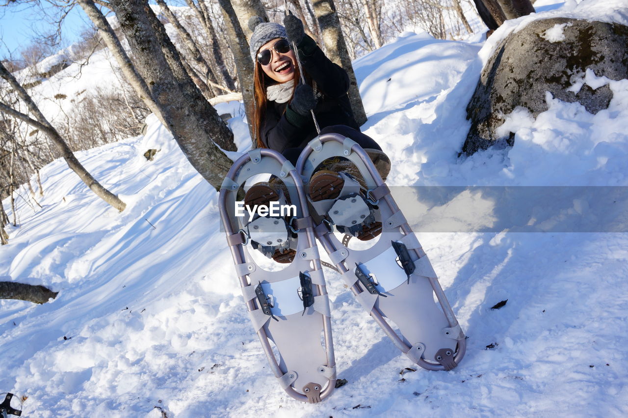 Full length of woman wearing snowshoe