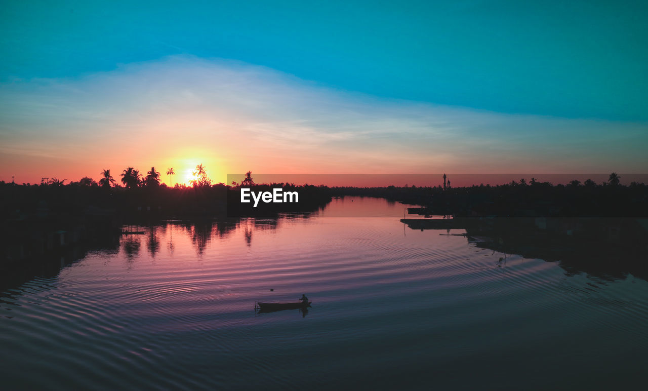 Scenic view of lake against sky during sunset