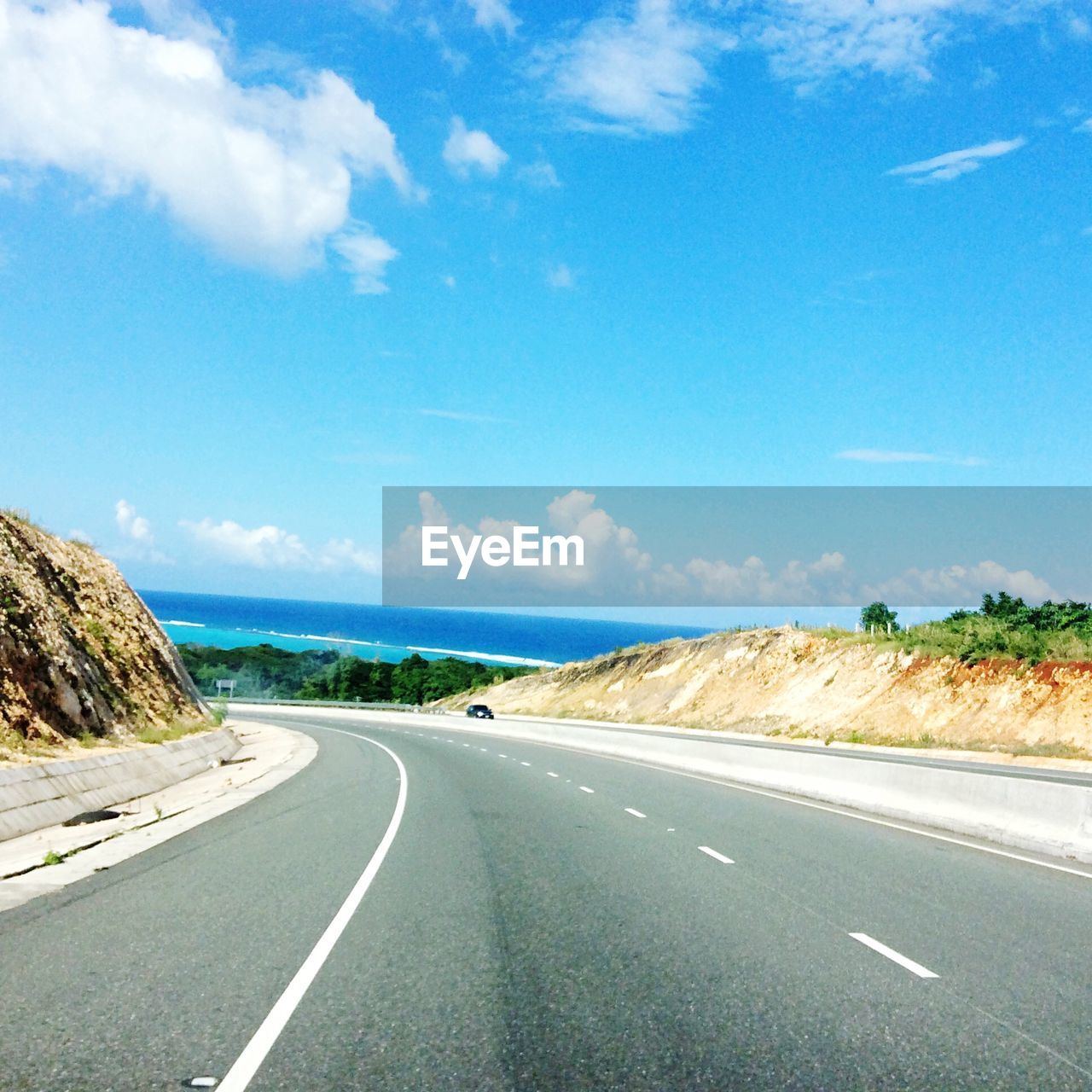 Empty road by landscape against sky, highway in jamaica 