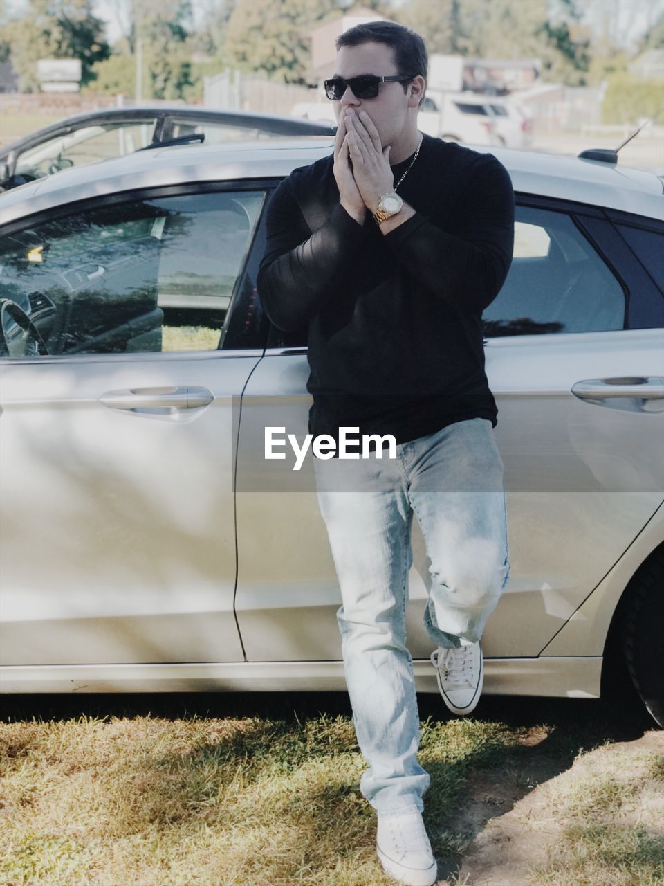 Full length of man standing by car