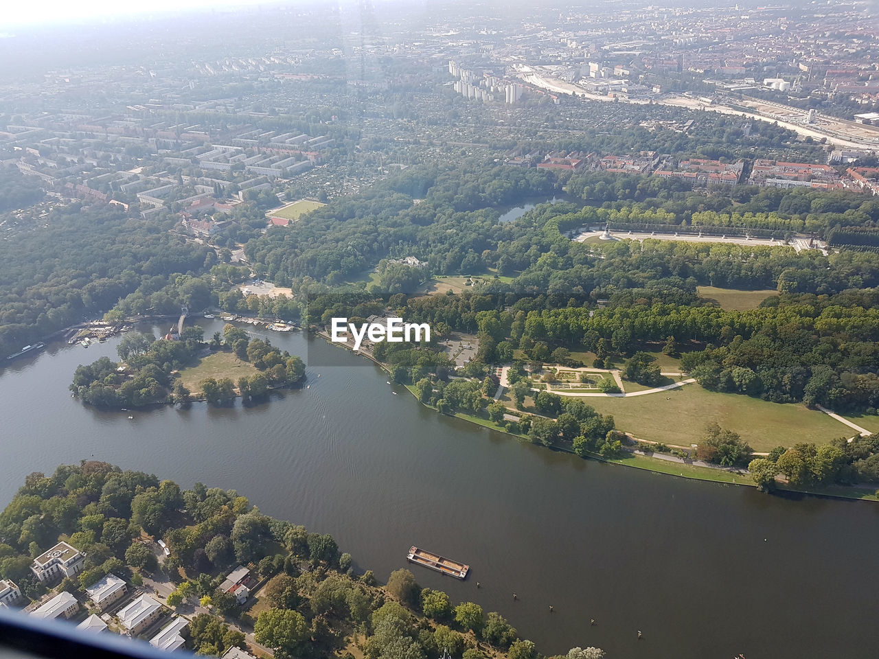 HIGH ANGLE VIEW OF RIVER AMIDST BUILDINGS