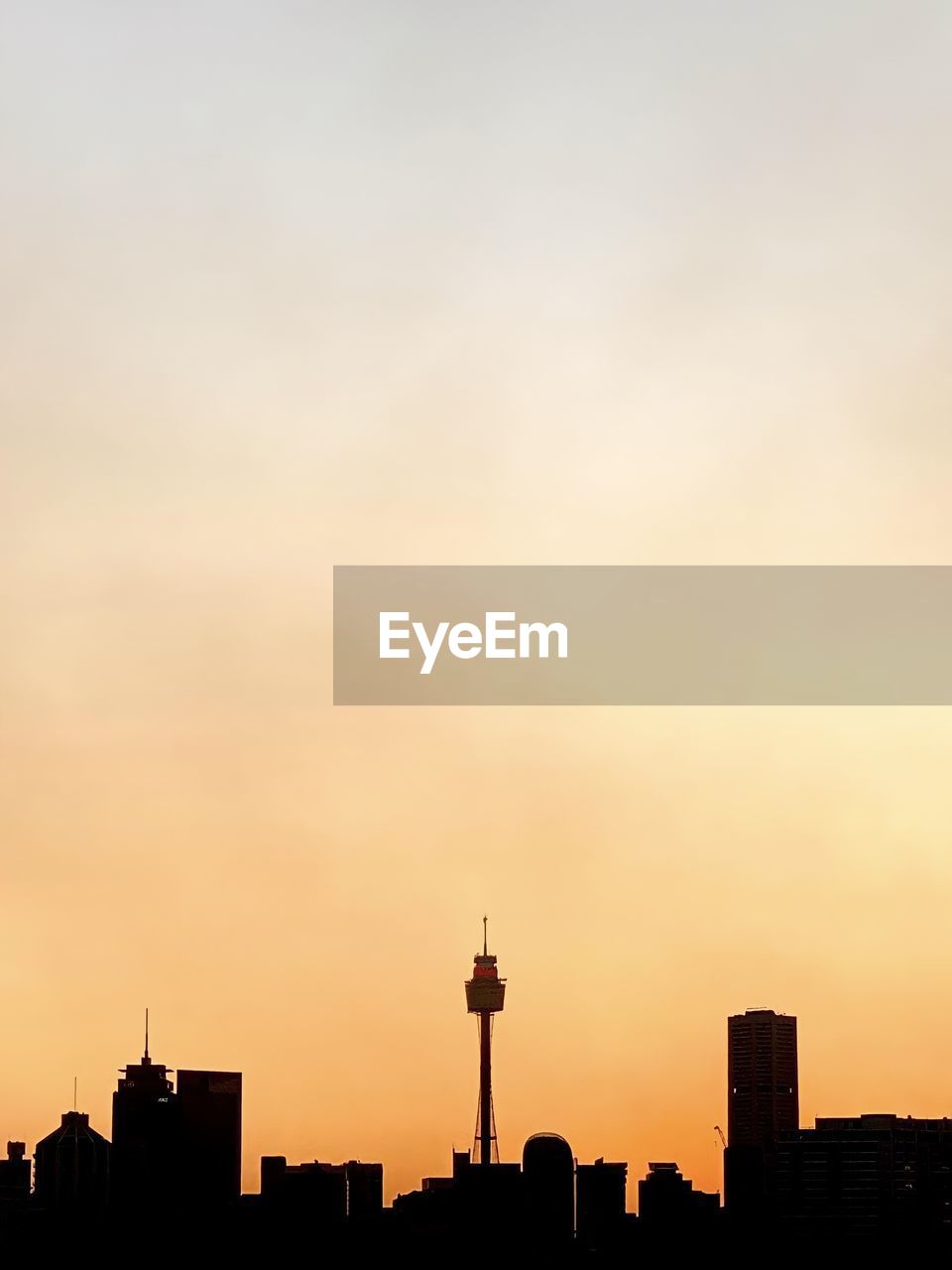 Silhouette of city skyline against sky during sunset