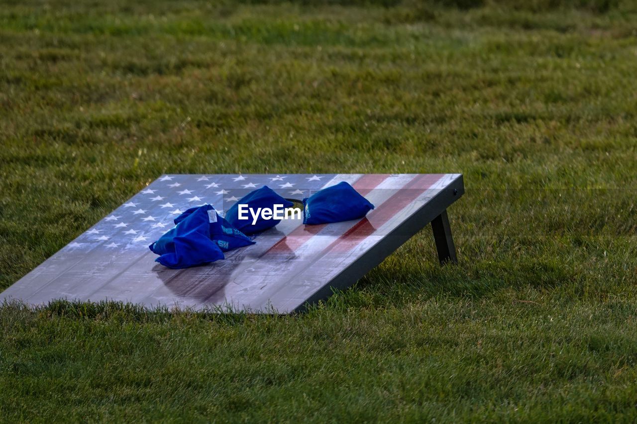 Patriotic bean bag toss game on grassy field in park