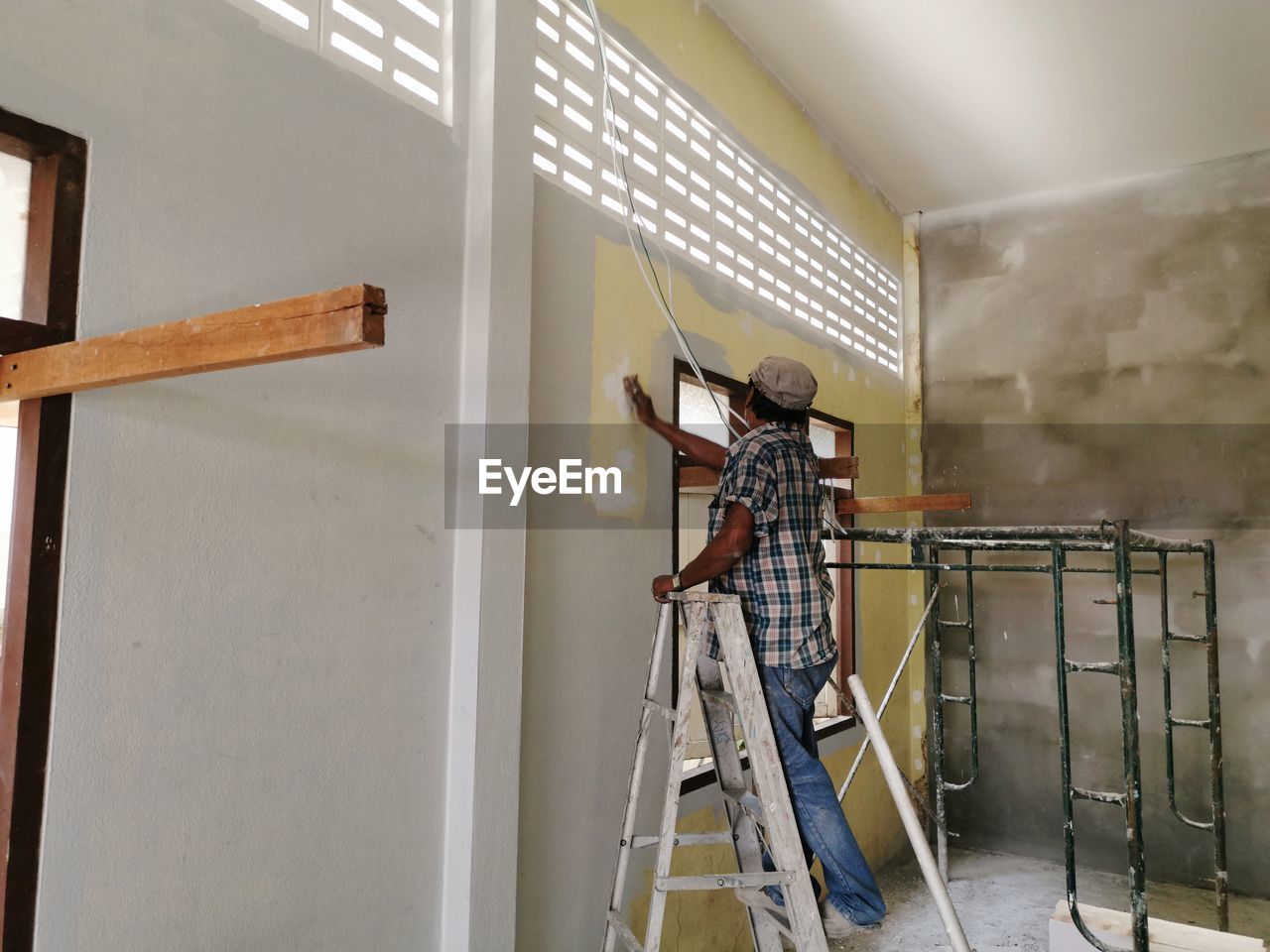 Man working on wall
